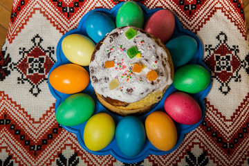 top view of decorated easter bread and dyed easter eggs