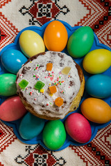 top view of decorated easter bread and dyed easter eggs