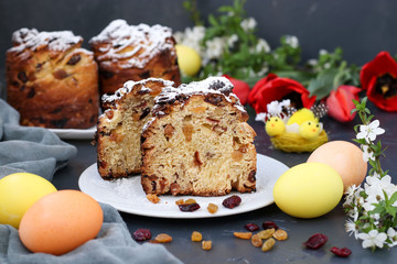 Fototapeta na wymiar Easter cake Craffin and colorful eggs on a dark background