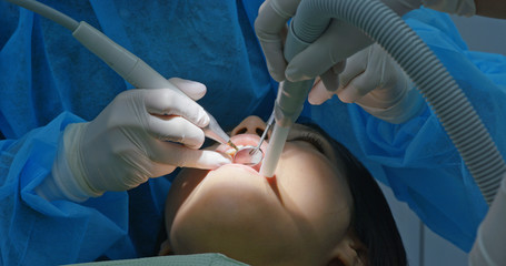 Woman under dental check up in clinic