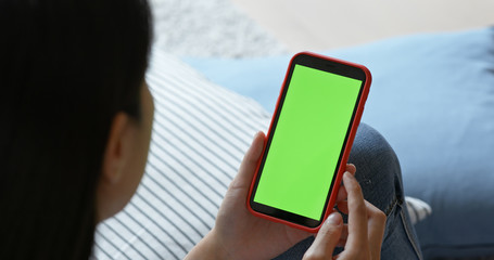 Woman hold with cellphone with green screen