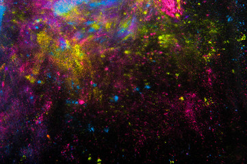 Colorful powder on black background. Abstract print. Holi paint
