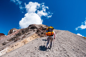 New Zealand, North Island, A group of backpacker hiking with a backpack in Tongariro Crossing track on a beautiful day.