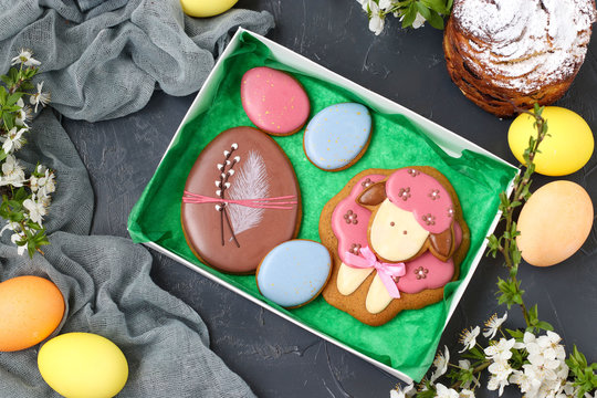 Easter gingerbread are located in a box on a dark background, top view