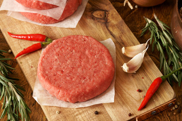 Raw beef burger, traditional barbecue, still life with vegetables and meat