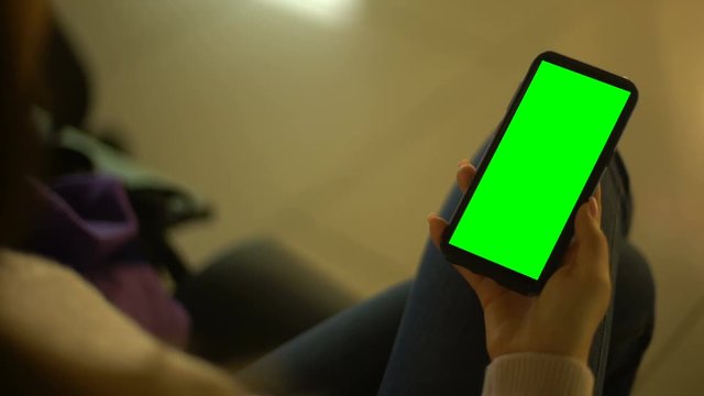 Young lady unlocking prekeyed phone screen, place for advertisement, device