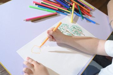 Happy mom and son draw and rejoice at home