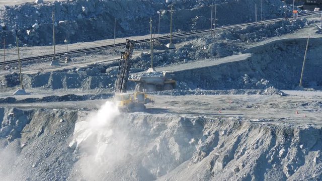 Open pit mine. A drilling rig drills a hole to set explosives in an asbestos mineral quarry.
