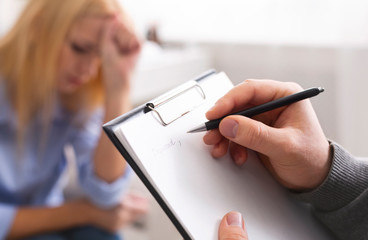 Pen in hands of smart professional male psychologist