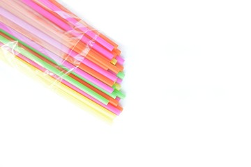 colored plastic drinking straws on a white background