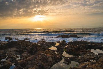 Ocean scenery, powerful waves and a colorful sunset in Portugal