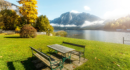 Majestic Mountain landscape in Austrian Alps in autumn, Altaussee lake and Face of Mount Trissel with fog and clouds, on the background. wonderful view of Altaussee village, Styria, Austria, Europe.