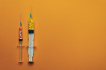 Two syringes with color drugs ( vitamins, dyes, flavor enhancers, nutritional supplements,...