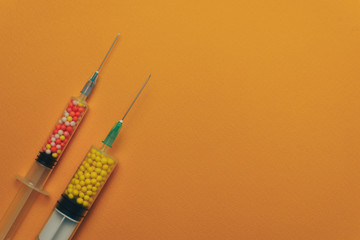 Two syringes with color drugs ( vitamins, dyes, flavor enhancers, nutritional supplements,...