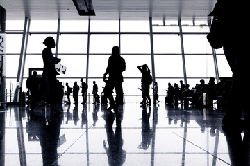 People in airport, silhouette of traveler