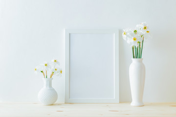Mockup with a white frame and white daffodils in a vase on a light background