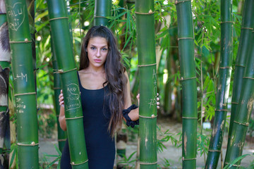 Fashion portrait of beautiful woman. Bamboo forest