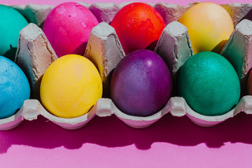 Easter background with Easter eggs. Top view with copy space. multicolored Easter eggs on a pink background
