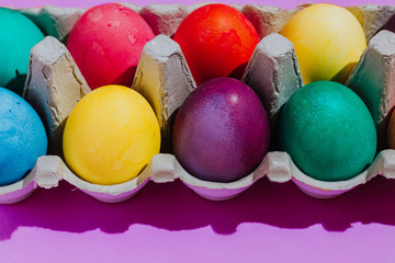 Easter background with Easter eggs. Top view with copy space. multicolored Easter eggs on a pink background