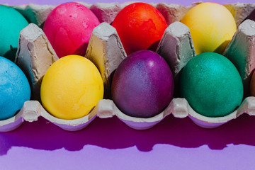 Easter background with Easter eggs. Top view with copy space. multicolored Easter eggs on a pink background