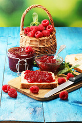 Toast bread with homemade raspberry jam or marmalade on table served with butter for breakfast or brunch