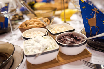 Naklejka na ściany i meble ariety of appetizers - olive paste, mayonnaise and other. Dinner table set up.