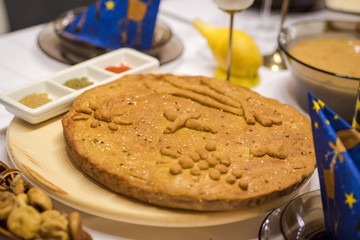 Homemade christmas bread. Balkan kitchen - homemade bread with a christian cross and christian symbols on it for the Christmas Eve.
