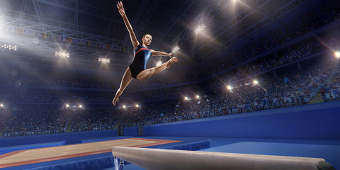 Fototapeta na wymiar Female athlete doing a complicated exciting trick on gymnastics balance beam in a professional gym. Girl perform stunt in bright sports clothes