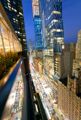 Amazing skyscrapers in Midtown Manhattan, aerial view from rooftop with traffic reflections on the...
