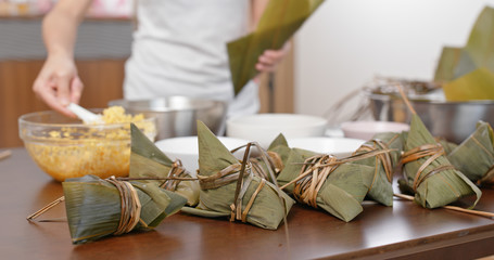 Fototapeta na wymiar Woman wrap rice dumpling at home