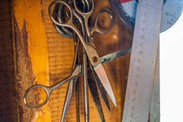 Old scissors and a ruler on a wall isolated