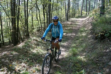 Naklejka premium A young woman riding a Bicycle on a forest trail, Crimea, Russia.