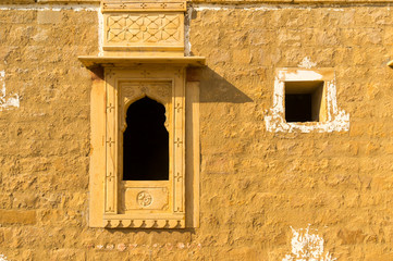Traditional arched window in a sandstone stone wall in kumbalgarh Jaisalmer