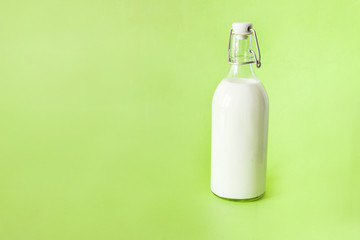 milk in a bottle on a green background