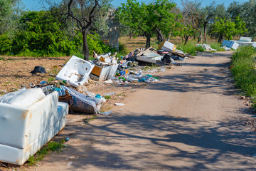 Big problem of environmental degradation. Plastic waste, non-functioning appliances and all kinds of waste left at the edge of a country road.