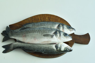 fresh fish with lemon and Rosemary on wooden board. mediterranean diet . healthy food