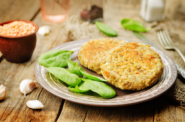 red lentil seeds cashew carrot burgers with fresh spinach leaves