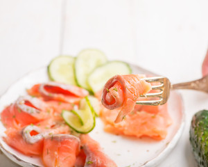salmon slices with microgreen and cucumber