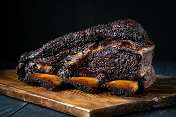 A large piece of smoked beef brisket on the ribs with a dark crust. Classic Texas BBQ