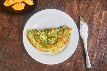 Omelet and a plate of fruit (watermelon and mango) is a traditional breakfast in Indonesia.