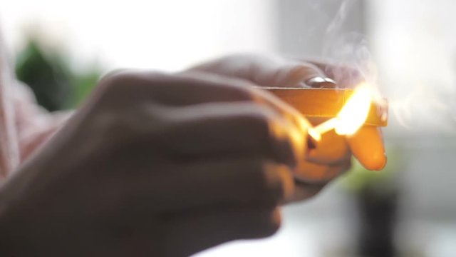 Girl's hand striking a match