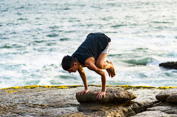 Summer yoga session on a beautiful golden beach of Lima in Peru yoga tour, Bakasana Crow Crane pose