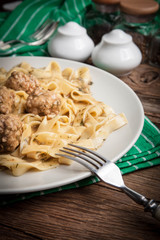 Tagliatelle pasta with beef meatballs.