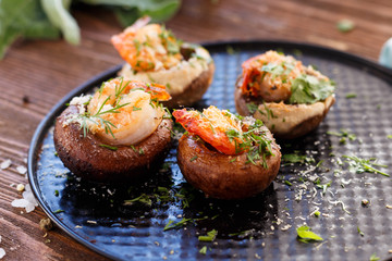 Mushrooms with shrimp. King prawns. Appetizzer. Snack. Dish.