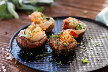 mushroom cap with shrimp. King prawns. Appetizzer. Snack. Dish.