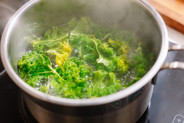 Cabbage boiled in pan. Arugula. Raw. Cooking. Making. Vegan. Green. Healthy food. 