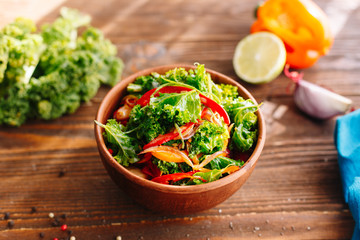 Cabbage salad with vegetables. Healthy food. Organic. Vitamin. Salat. Kitchen. Wooden table. Ingridients.