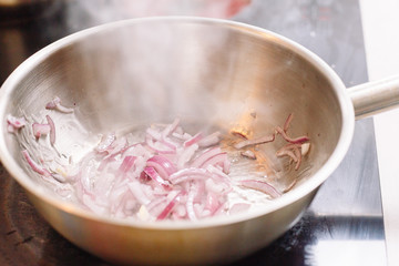 Onion boiled in pan. Fried. Cooking. Making. Kitchen.