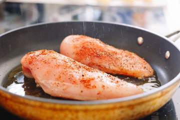 Raw chicken grilled in a skillet. With spices. Kitchen. Making. Meat.  Fried.