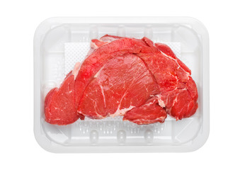 Fresh raw organic slice of braising steak fillet in plastic tray on white background.